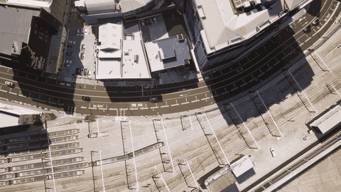The generated Unreal world over a rail corridor, showing native landscape, road markings, vehicles and building materials all resolved from source data